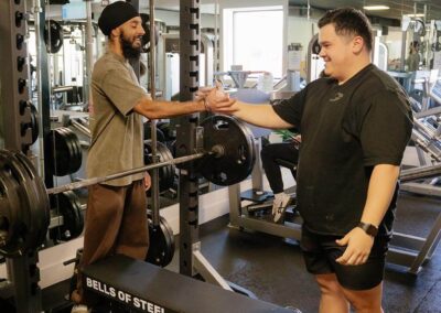 Needs Gym shaking hands with client